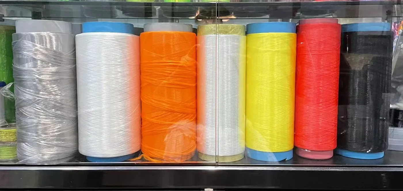 Coloured UHMWPE raw-yarn cones photographed as a range