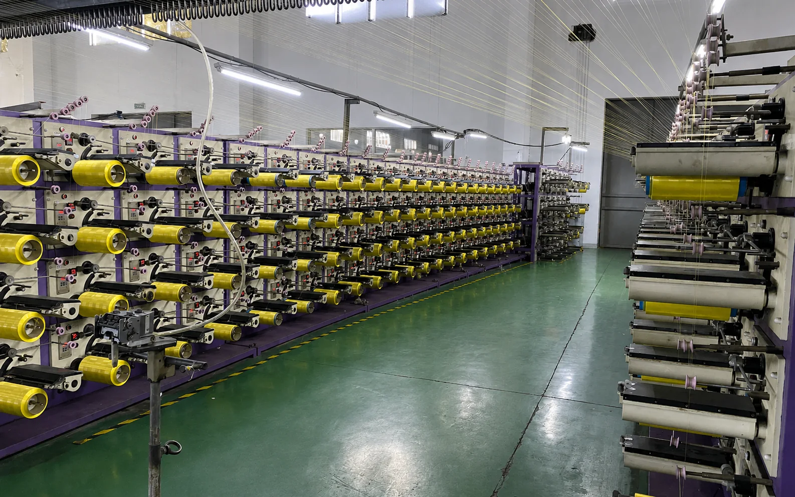 Bobbins loaded on a yarn creel before winding